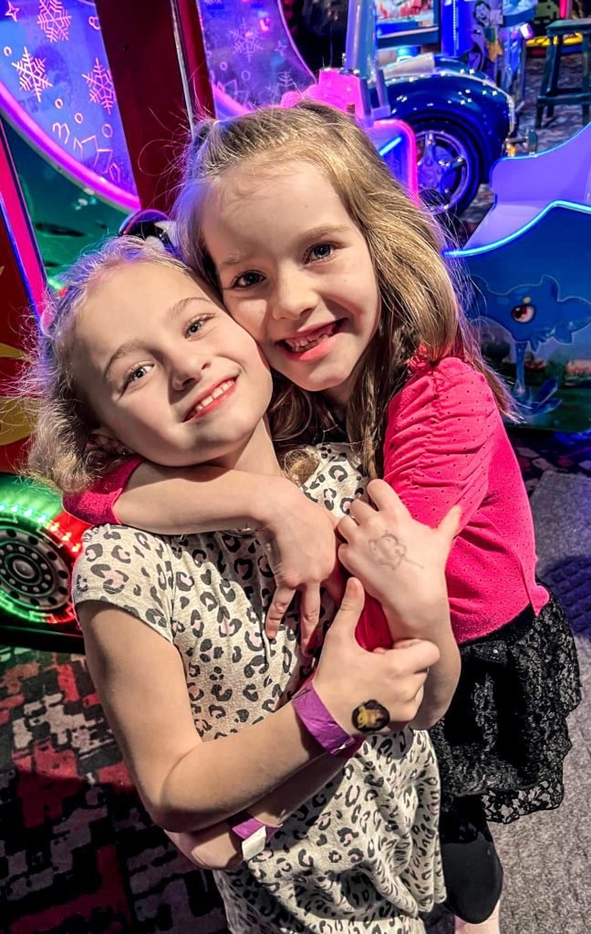 Children embrace after indoor activities